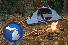 michigan map icon and camping tent at a wilderness campsite