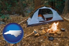 north-carolina map icon and camping tent at a wilderness campsite