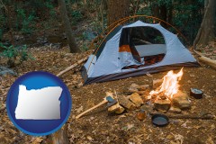 oregon map icon and camping tent at a wilderness campsite