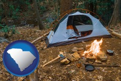 south-carolina map icon and camping tent at a wilderness campsite